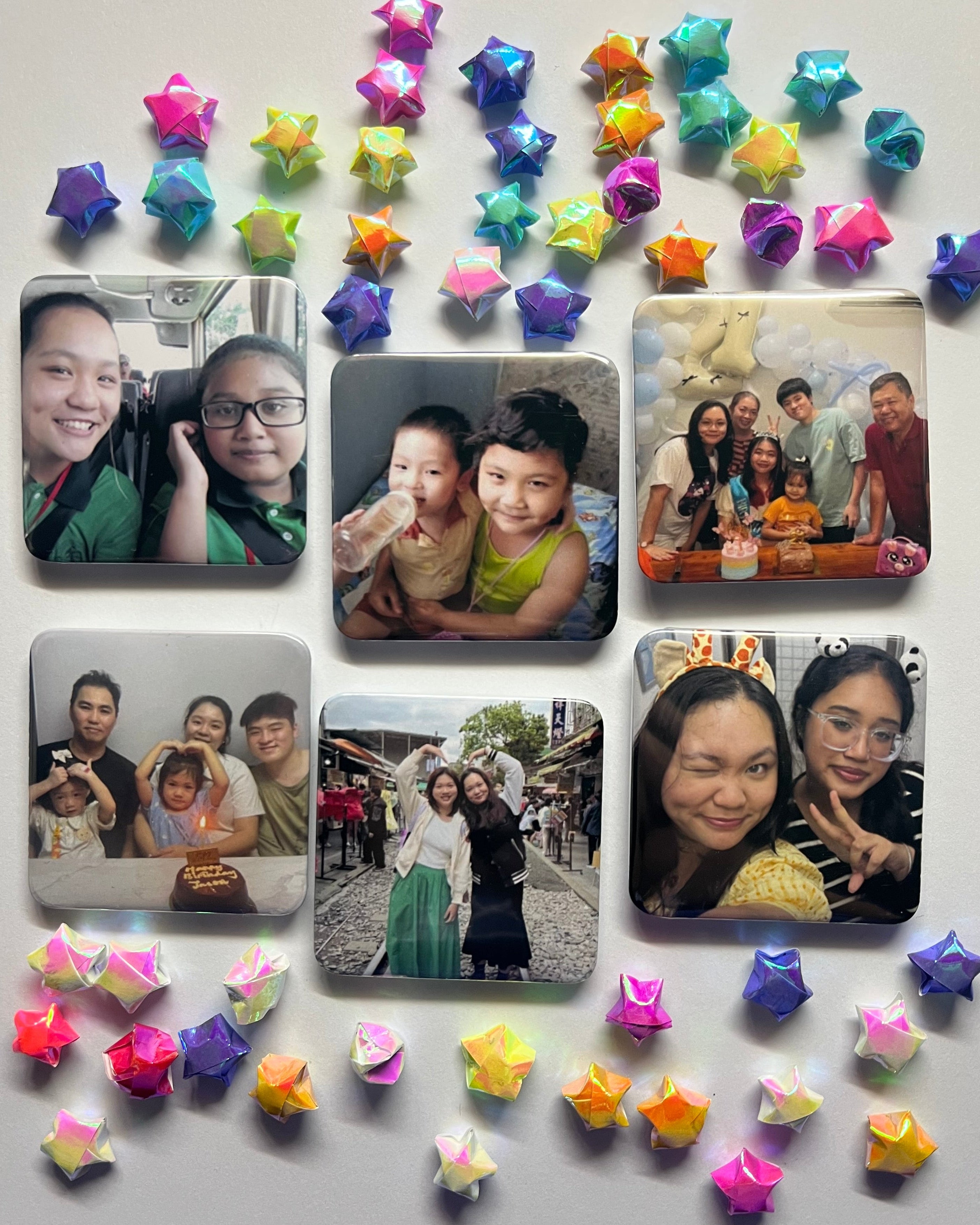Collection of family photos on a surface with decorative star-shaped items.